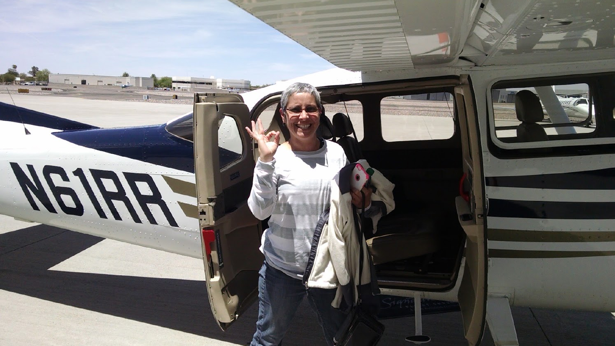 Passenger standing beside a small airplane